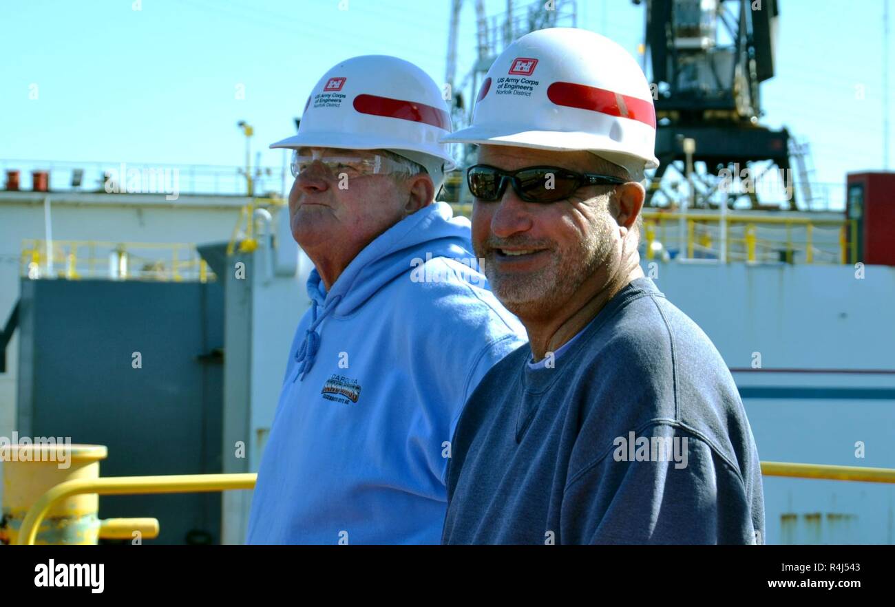 Left to right, Glen Boykin, derrick boat Elizabeth marine machinery mechanic, and Richard Bruton, DB Elizabeth captain, stand on the deck of the DB Elizabeth as it sits dry docked at Colonna's Shipyard Inc., Norfolk, Va., Oct. 29, 2018. The boat, part of the USACE fleet, is often used for debris removal and light marine construction work. Stock Photo