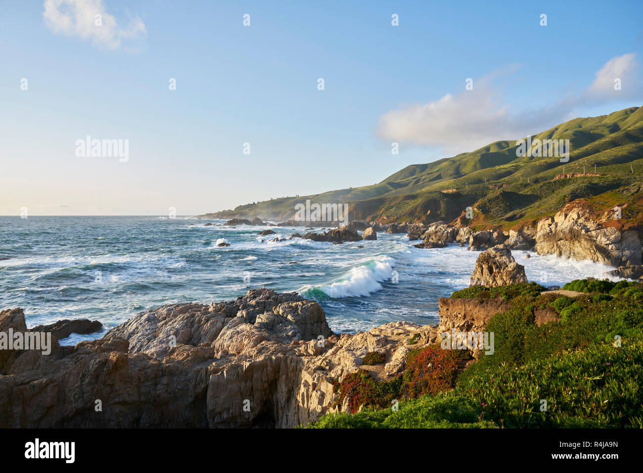 Waves by cliffs in Big Sur, USA Stock Photo