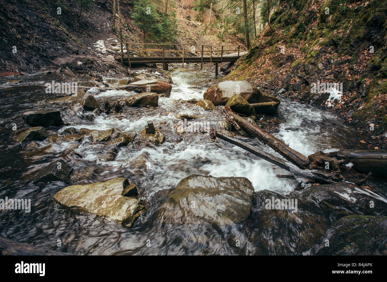mountain river and wooden bridge Stock Photo - Alamy