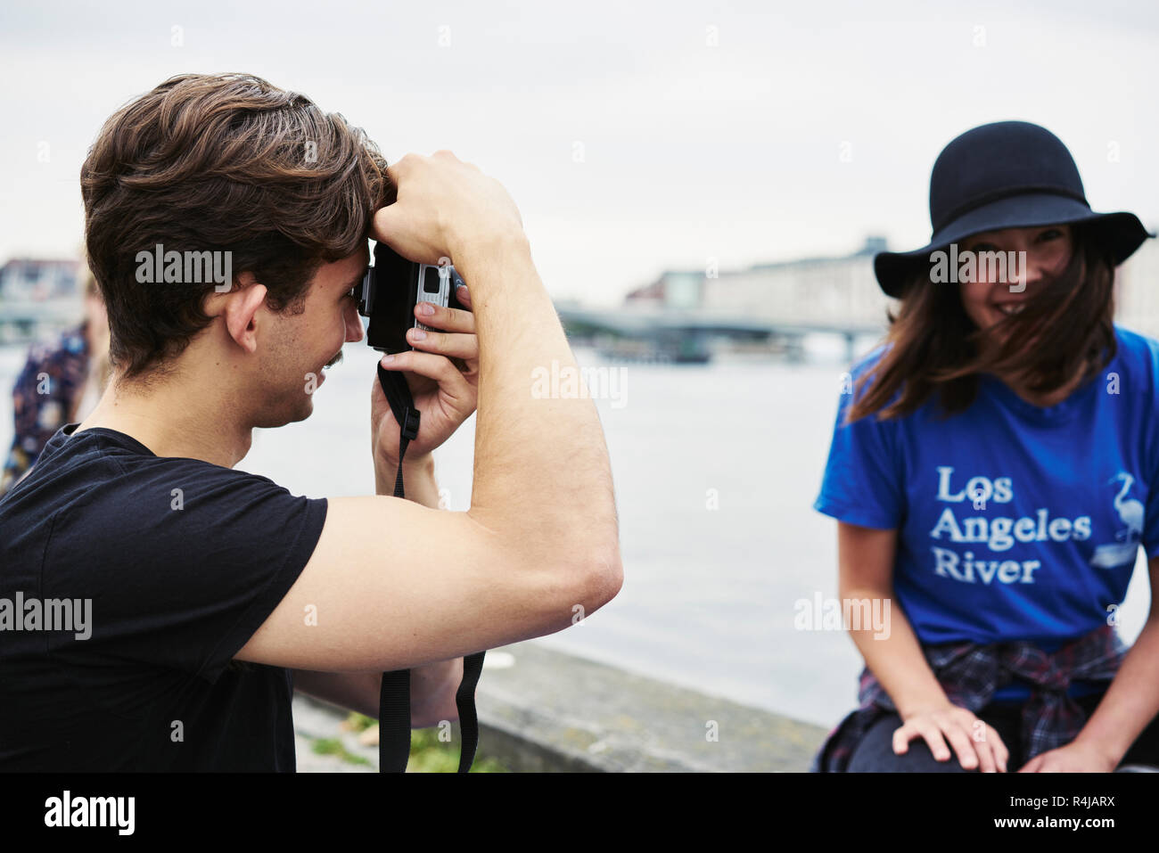 Young man taking a photo of a mid adult woman in Copenhagen, Denmark Stock Photo