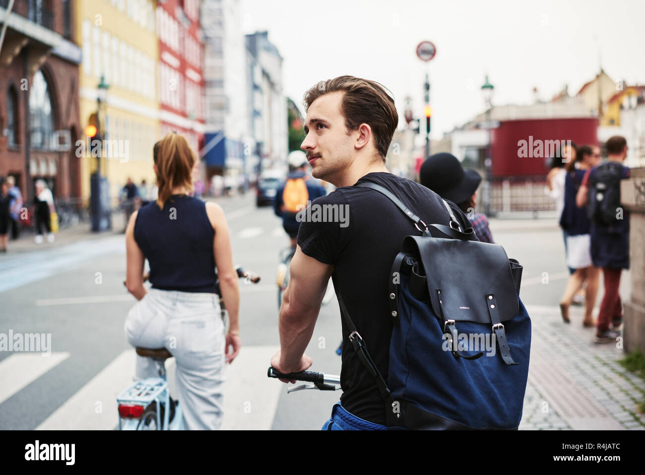 Young man riding a bicycle in Copenhagen, Denmark Stock Photo