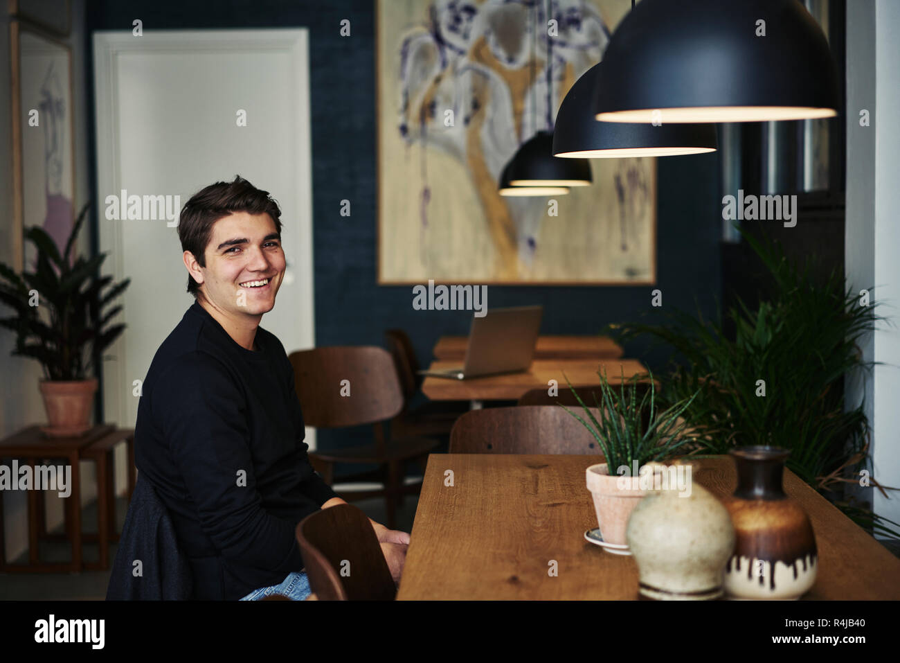 Young man sitting in a cafe in Copenhagen, Denmark Stock Photo