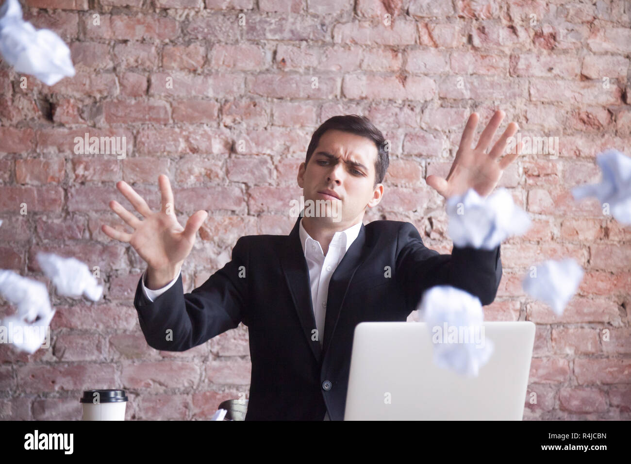 Angry tired businessman quits job, throws crumpled paper Stock Photo