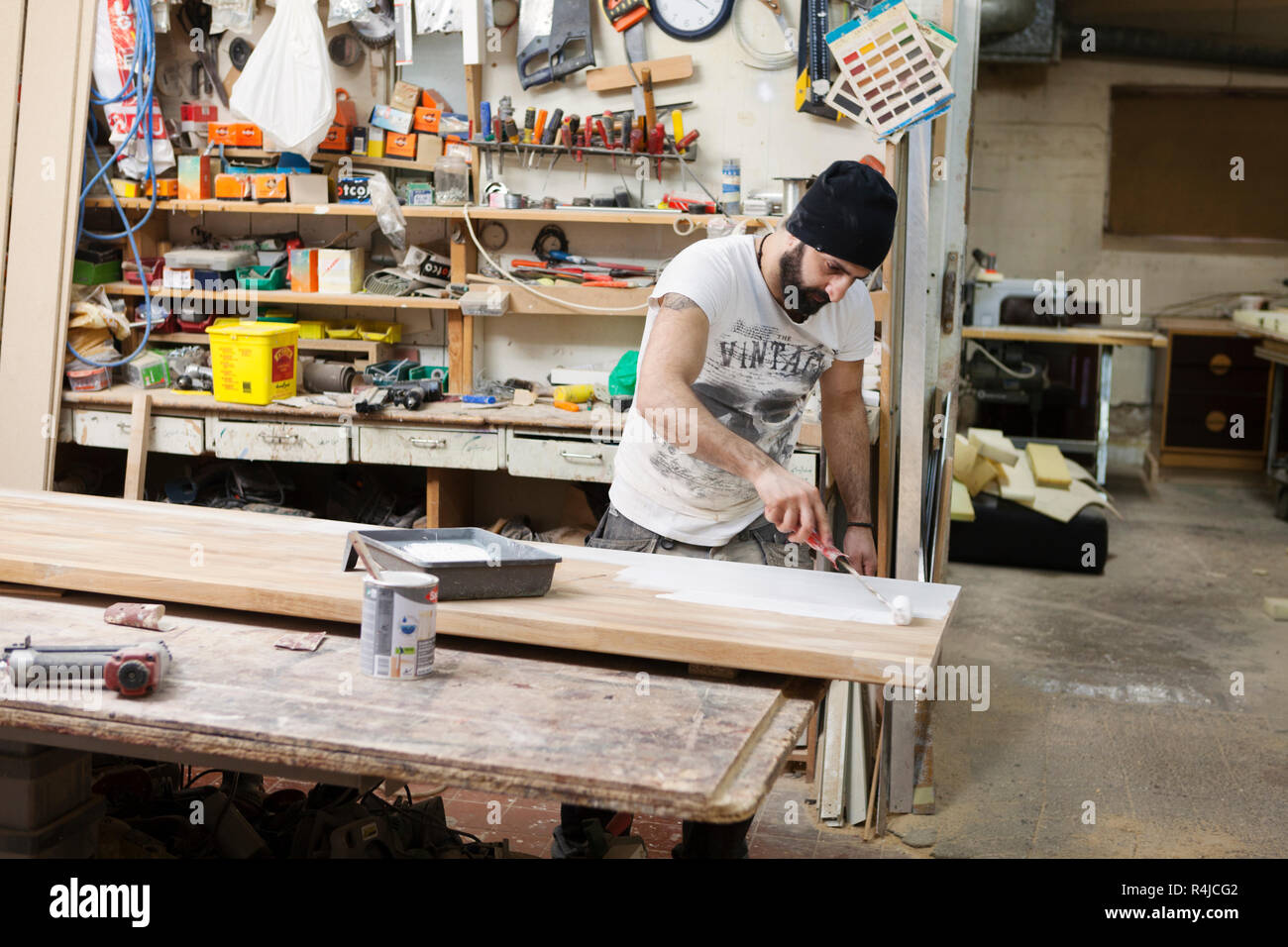 Carpenter painting with a paint roller in Sweden Stock Photo Alamy