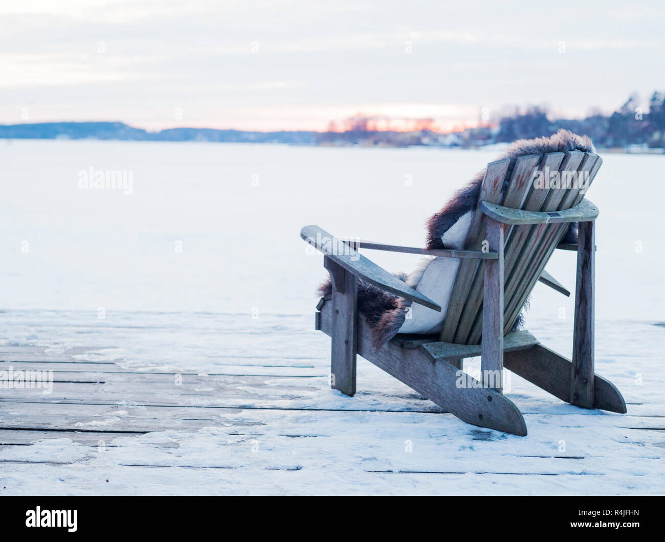 Wooden chair on deck in snow in Sigtuna, Sweden Stock Photo