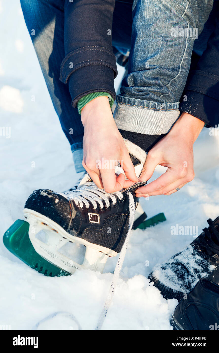 Lacing ice skates in Sweden Stock Photo Alamy