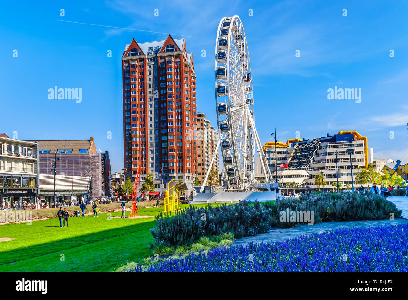 Modern Ferris Wheel surrounded by modern high rise buildings in the center of Rotterdam near Market Hall square in the Netherlands Stock Photo