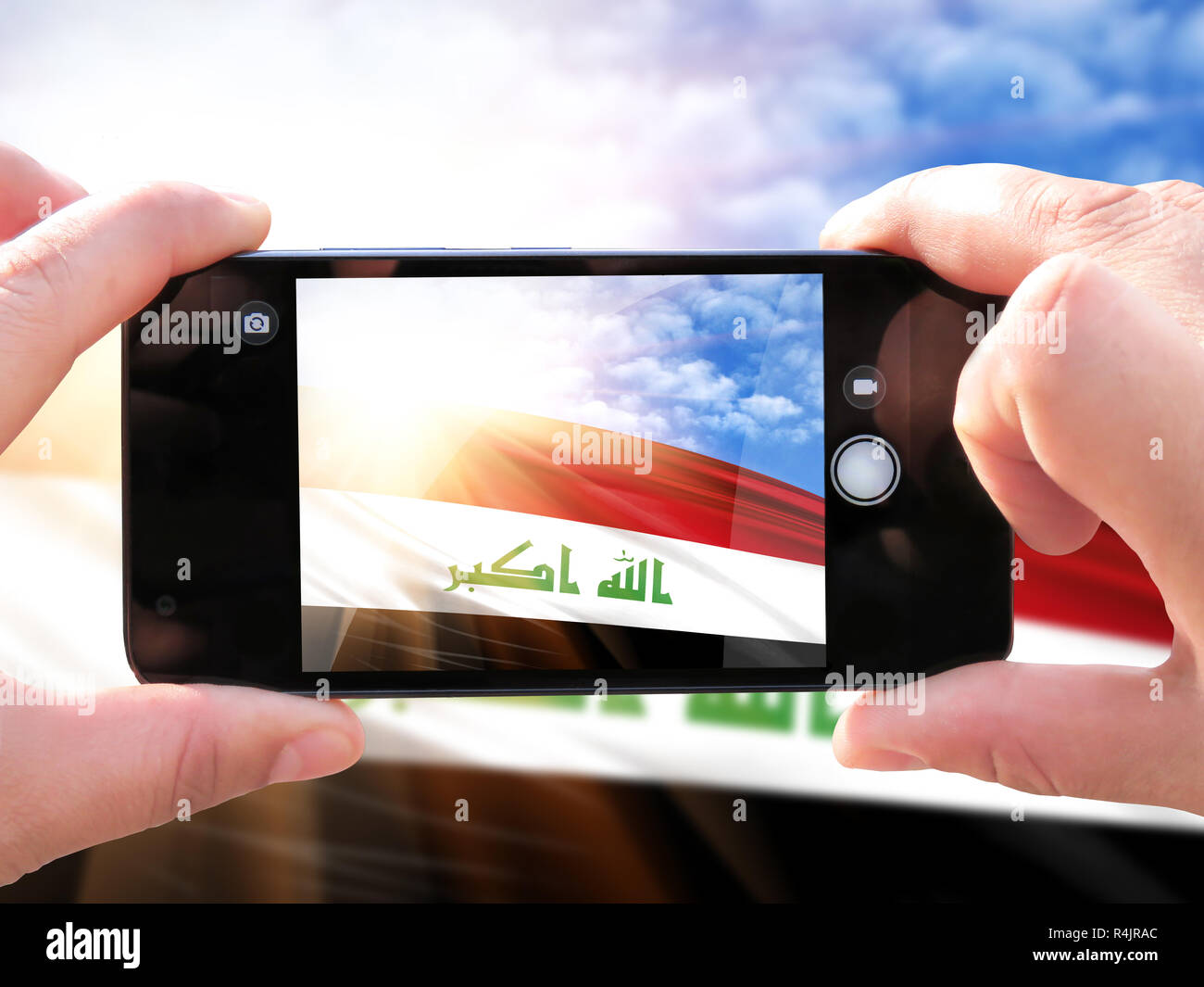 The concept of tourism and travel. The hands of men make a phone photograph of the flag of Iraq. On the smartphone close-up image of the flag. Photos  Stock Photo