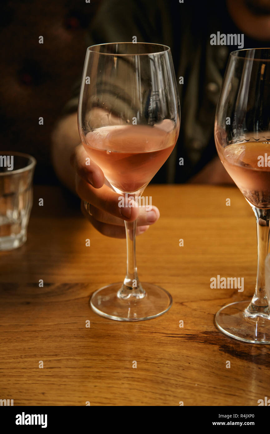 A glass of chilled rose wine in male hand Stock Photo Alamy