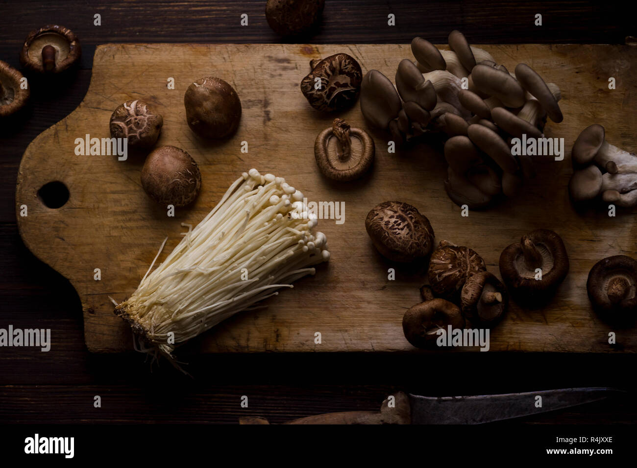 Enoki, shiitake and oyster mushrooms on cutting board Stock Photo Alamy