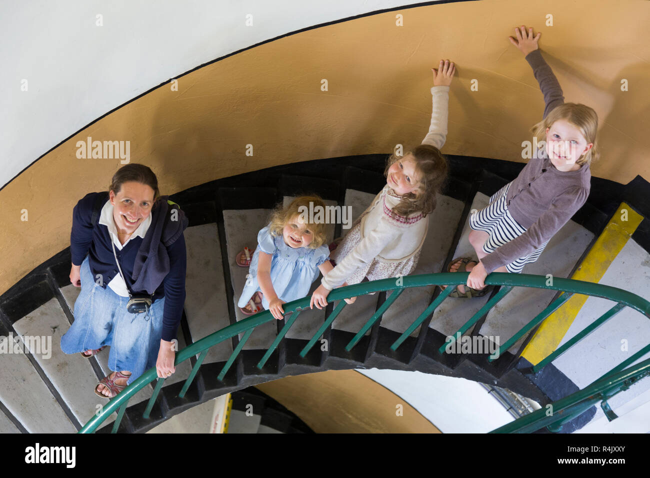 Mother mum and family of children / kids / tourists / visitors descend the spiral staircase inside Saint Catherine's Lighthouse on the Isle of Wight. UK England. (98) Stock Photo