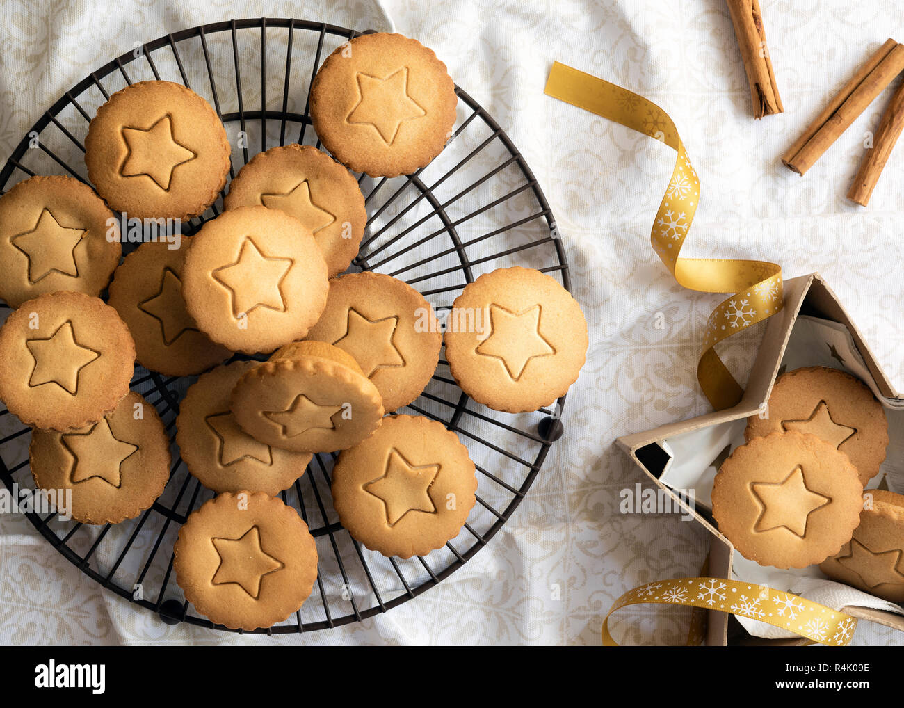 Small fruit mince pies on a cake rack and in a gift box Stock Photo Alamy