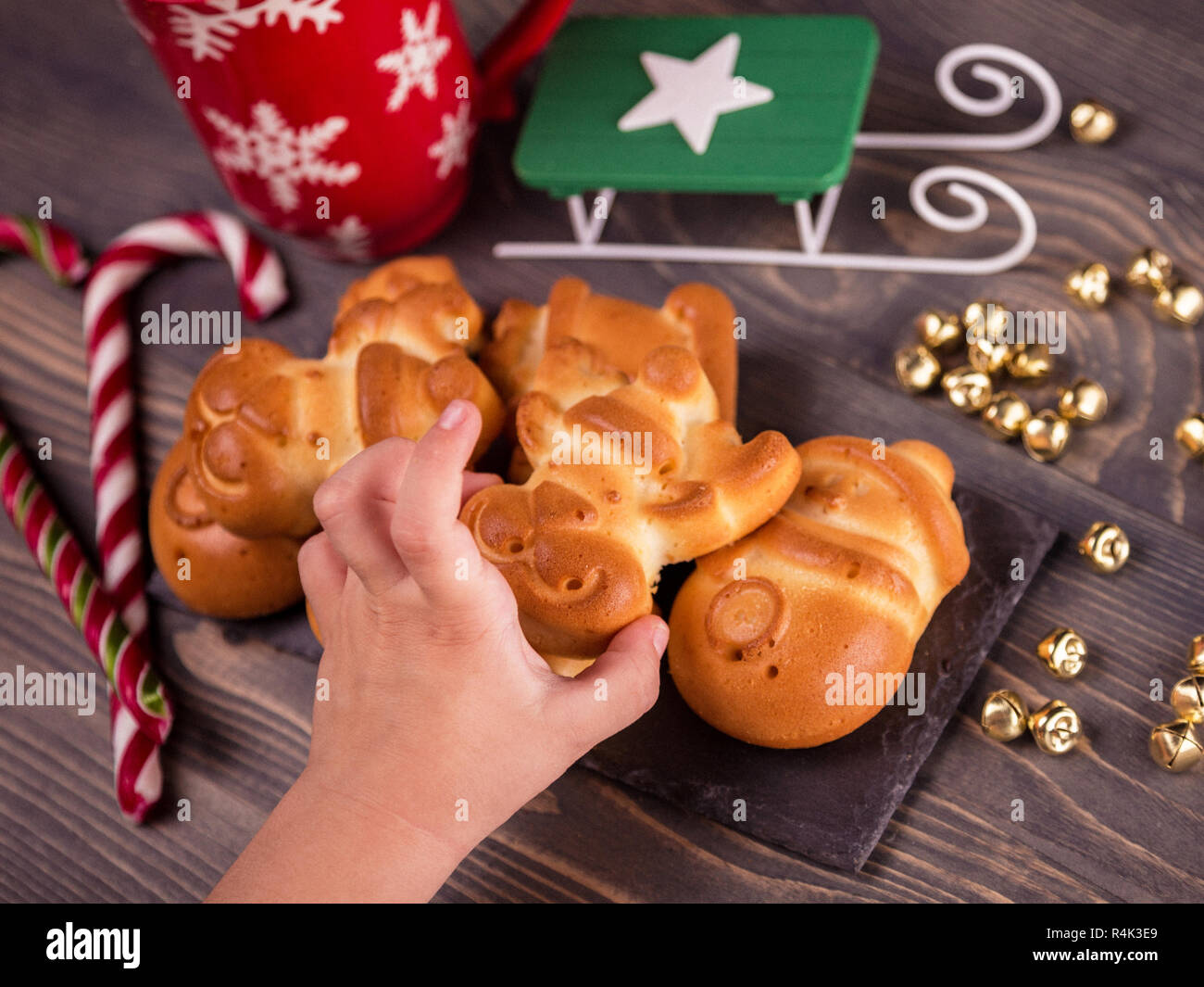 Children's hand takes ruddy gingerbread. Stock Photo
