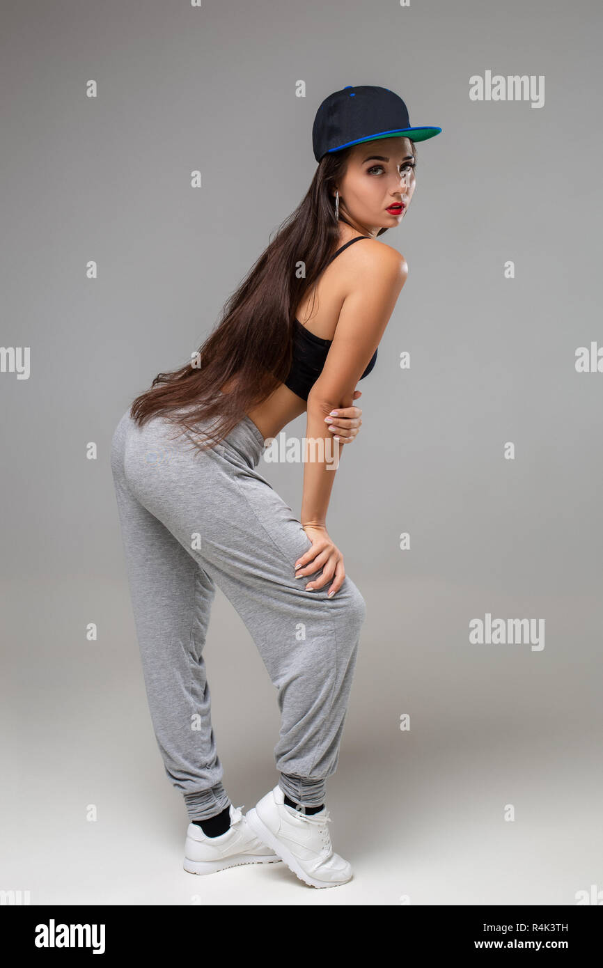 Modern dancer poses in front of the gray studio background. Modern ...