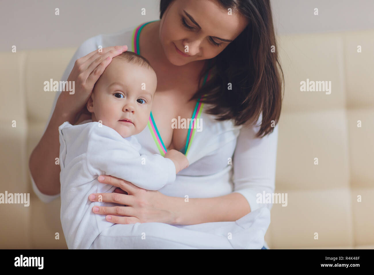 Baby eating mother's milk. Mother breastfeeding baby. Beautiful mom