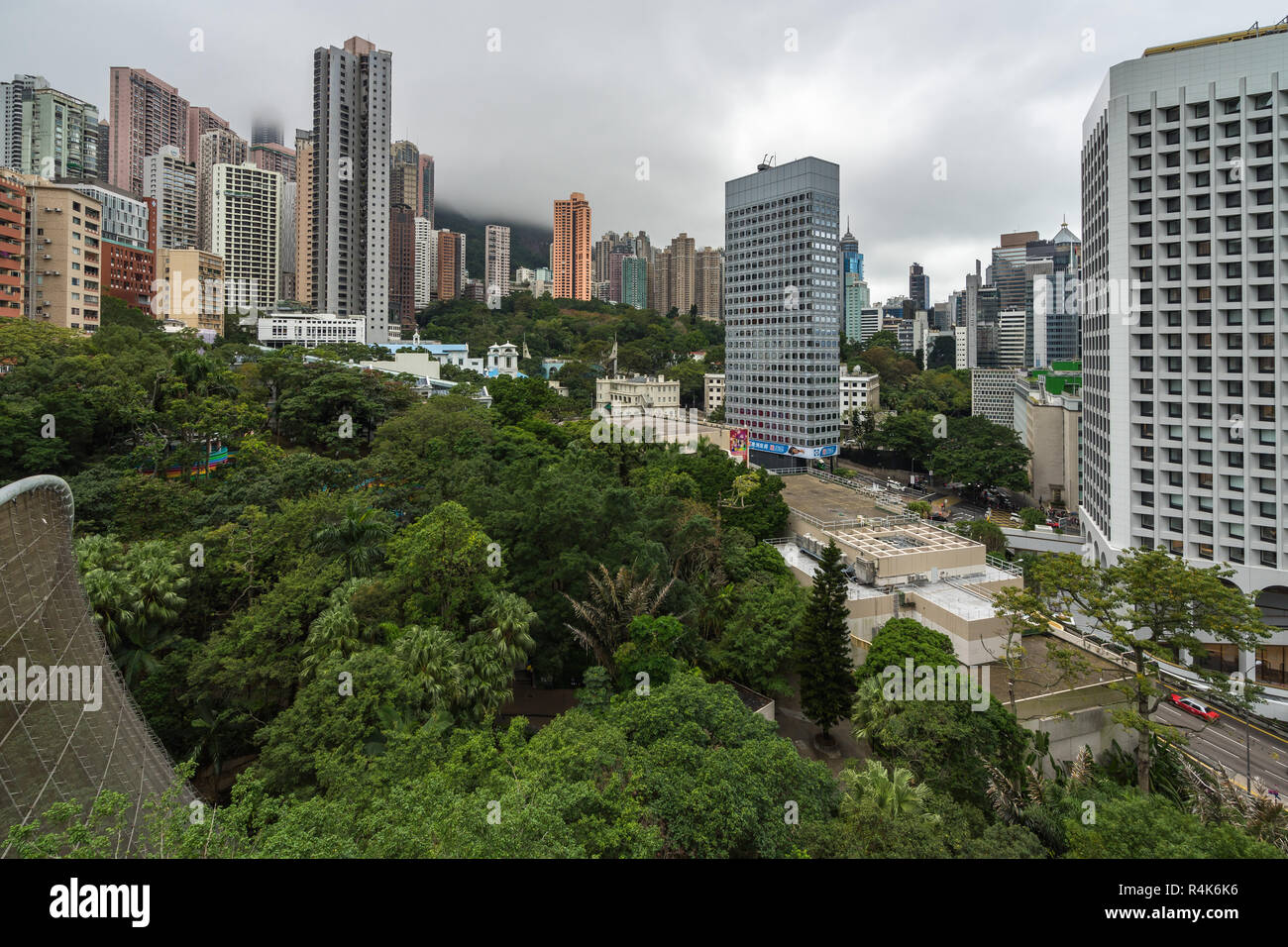 Aerial view of Hong Kong Park surrounded by skyscrapers of Central and Admiralty business districts. Hong Kong, January 2018 Stock Photo