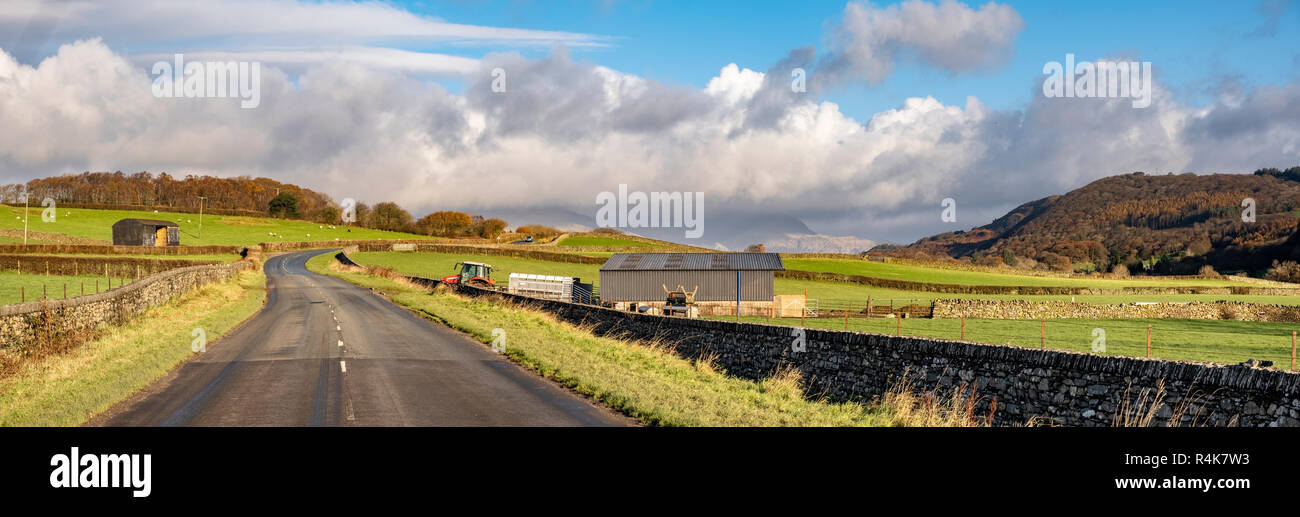 The A5084 leads into the Lake District from the Furness Peninsula in Cumbria as it passes through Lowick Bridge in the Crake Valley.  I have been mean Stock Photo