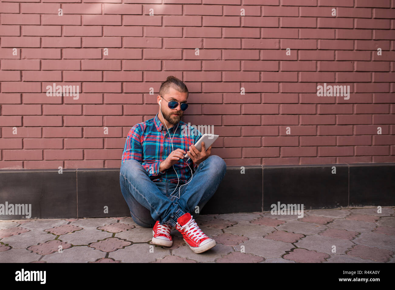 Handsome hipster guy working on digital tablet. Stock Photo