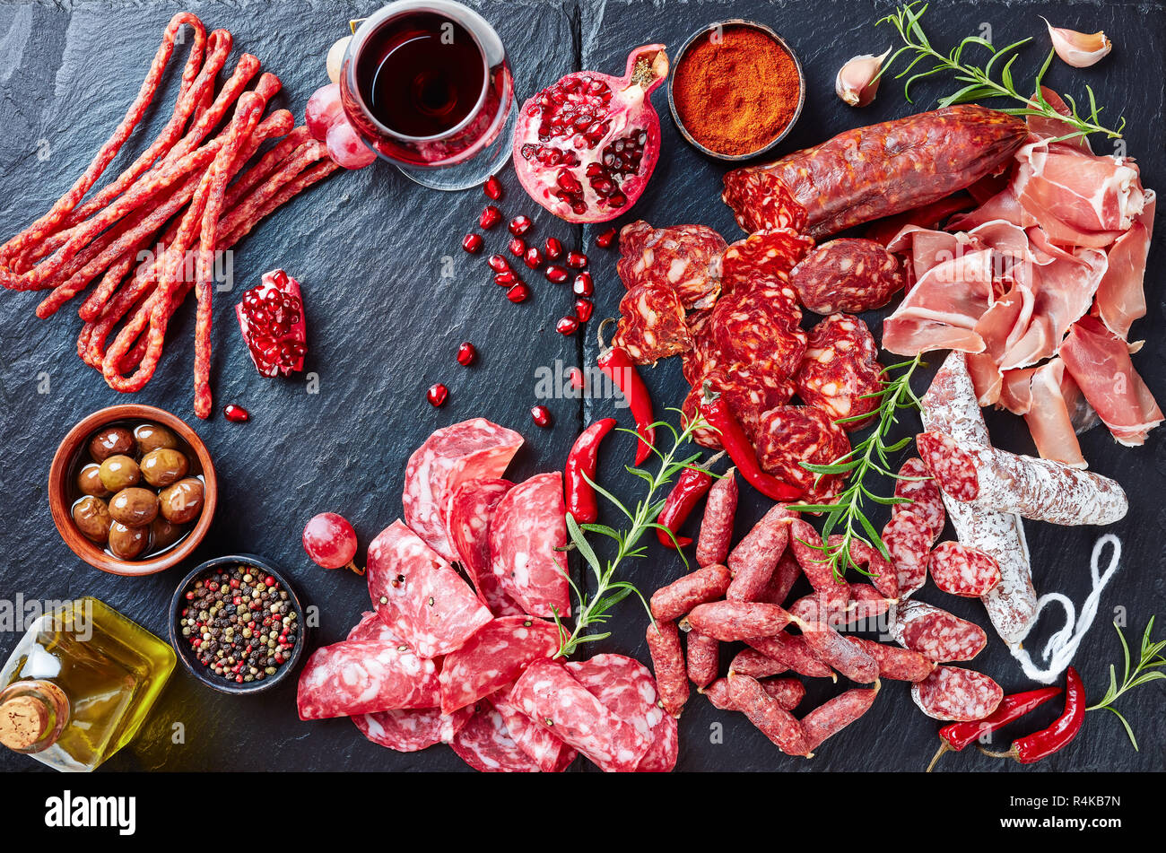 Tapas selection. A stone cutting board with charcuterie. Spanish cured meat, jamon, chistorra
