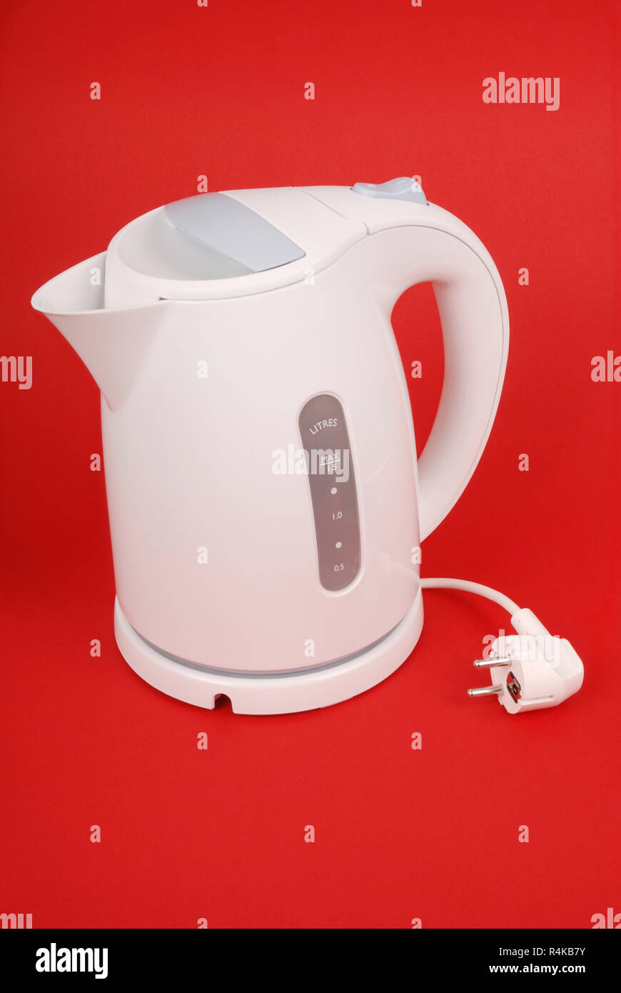 White electric kettle isolated on red background Stock Photo