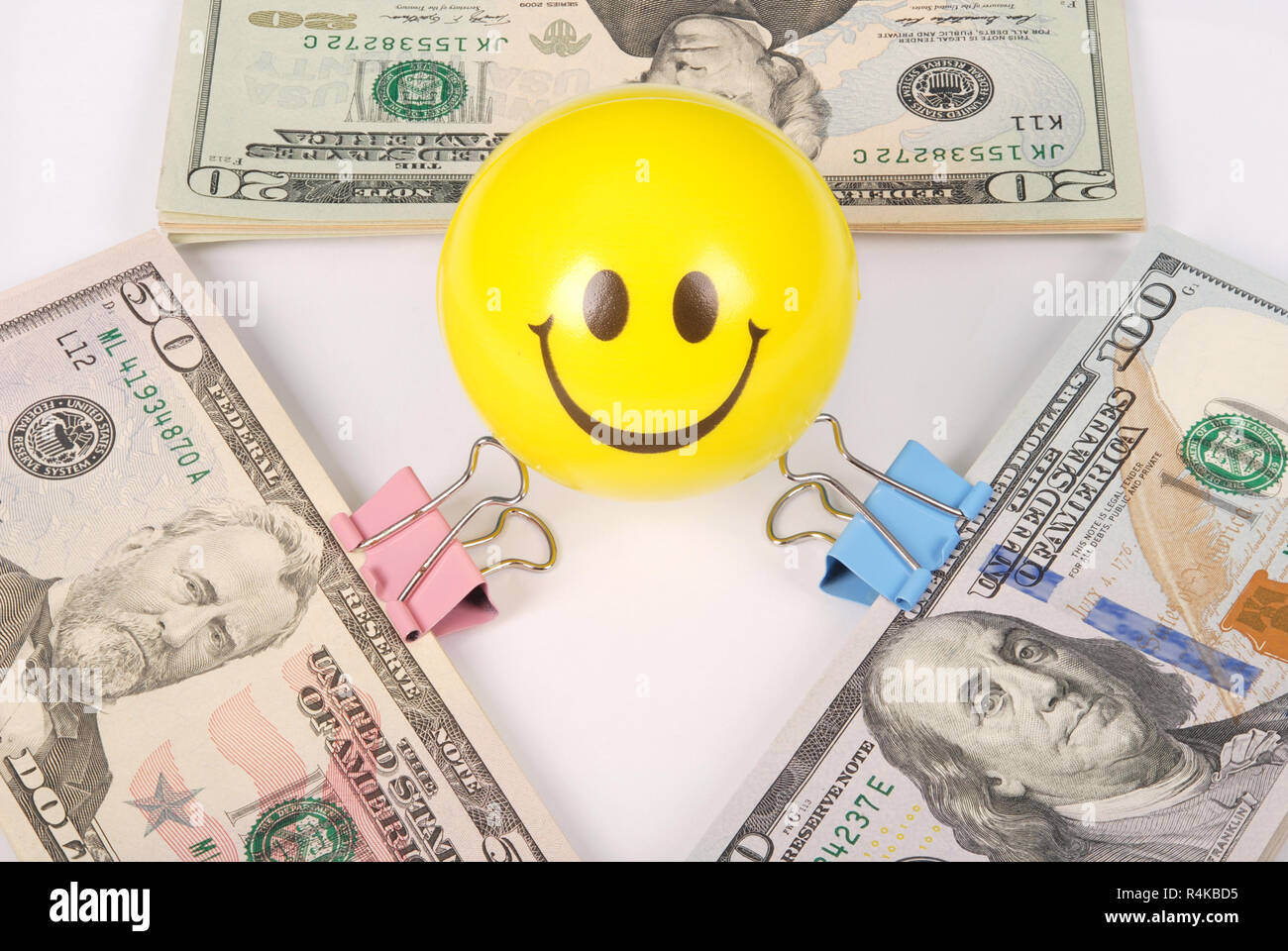 Yellow smile faces on money. Abstract money background isolated on white Stock Photo