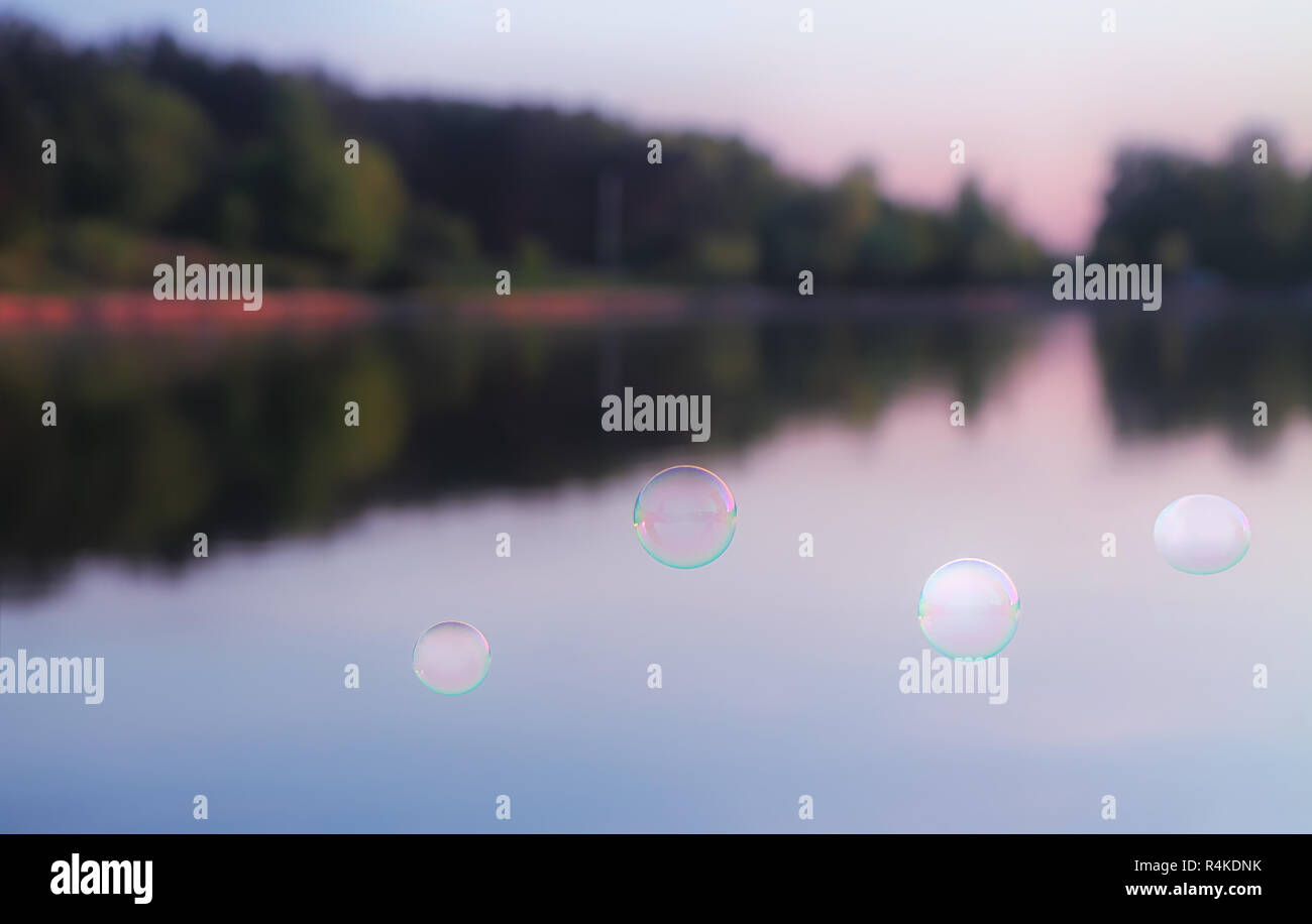 Soap Bubbles Against The Blurred Nature Background Stock Photo - Alamy