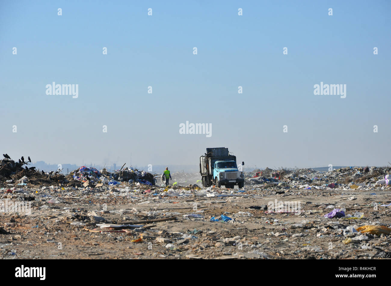 Truck and workers in municipal garbage dump Stock Photo - Alamy
