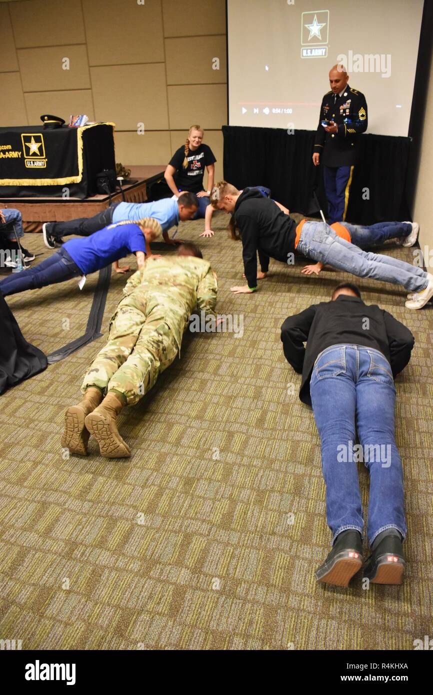 Sgt. 1st Class Fernando Gonzalez (top right), station leader, Scottsdale Recruiting Station, oversees a push-up contest involving attendees at the Arizona Health Occupations Students of America (HOSA) Fall Leadership Conference Extravaganza (FLEX), Nov. 1, Phoenix Convention Center. HOSA’s mission is defined as enhancing the delivery of compassionate, quality health care by providing opportunities for knowledge, skill and leadership development of all health science education students, helping the student meet the needs of the health care community. Stock Photo