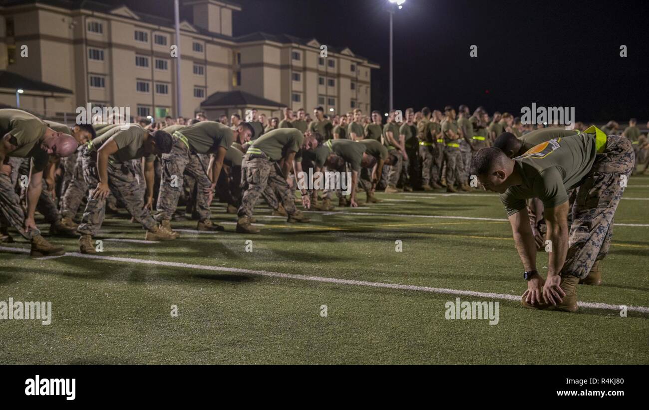 U.S. Marines with 3rd Marine Regiment, 3rd Marine Division stretch before the Regiment's 2nd annual Bougainville Day run on Marine Corps Base Hawaii, Kaneohe Bay, Nov. 1, 2018. Bougainville Day remembers and honors the Regiment’s history. Stock Photo