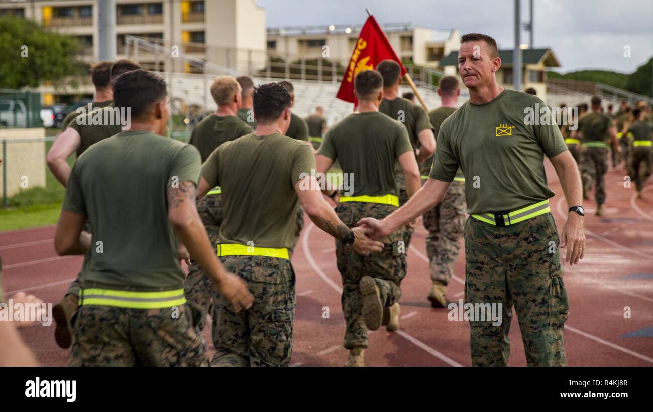 U.S. Marine Corps Col. Michael Styskal, commanding officer, 3rd Marine Regiment, 3rd Marine Division high fives Marines at the end of the Regiment's 2nd annual Bougainville Day run on Marine Corps Base Hawaii, Kaneohe Bay, Nov. 1, 2018. Bougainville Day remembers and honors the Regiment’s history. Stock Photo