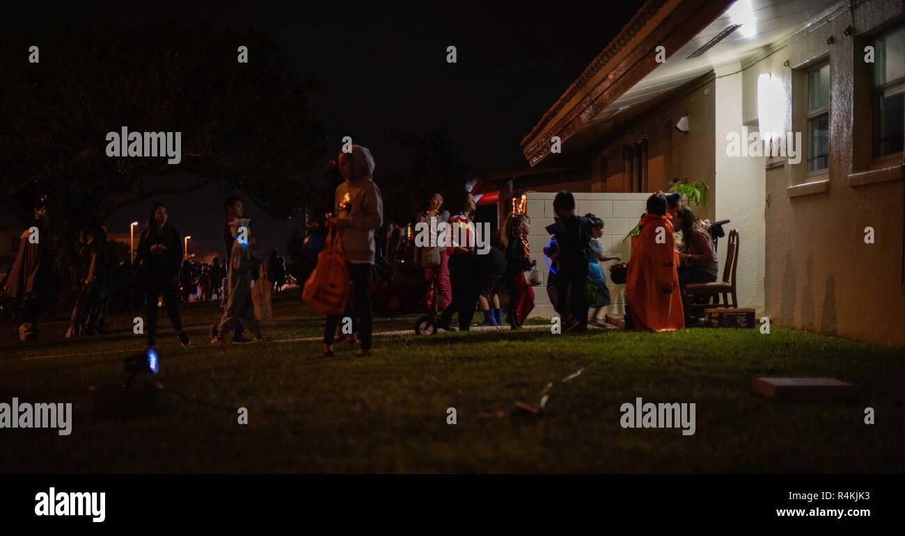 Japanese and American trick-or-treaters line up for candy at a Team Kadena member’s house during Halloween on Kadena Air Base, Japan, Oct. 31, 2018. Each year, Team Kadena members host Halloween on Kadena for Okinawan and American children to trick-or-treat. Stock Photo
