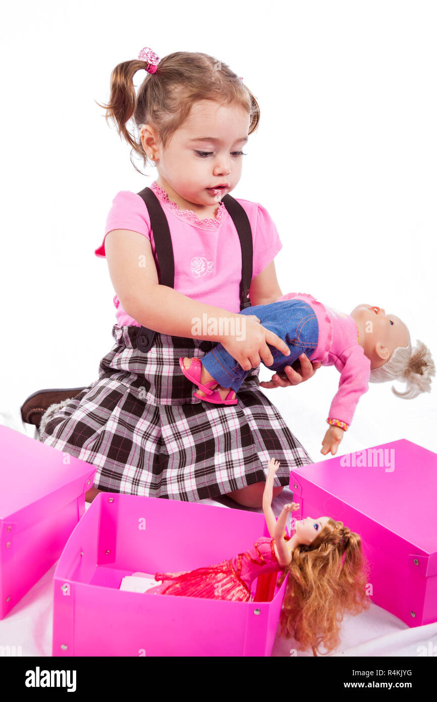 Sweet little blonde girl playing with dolls Stock Photo