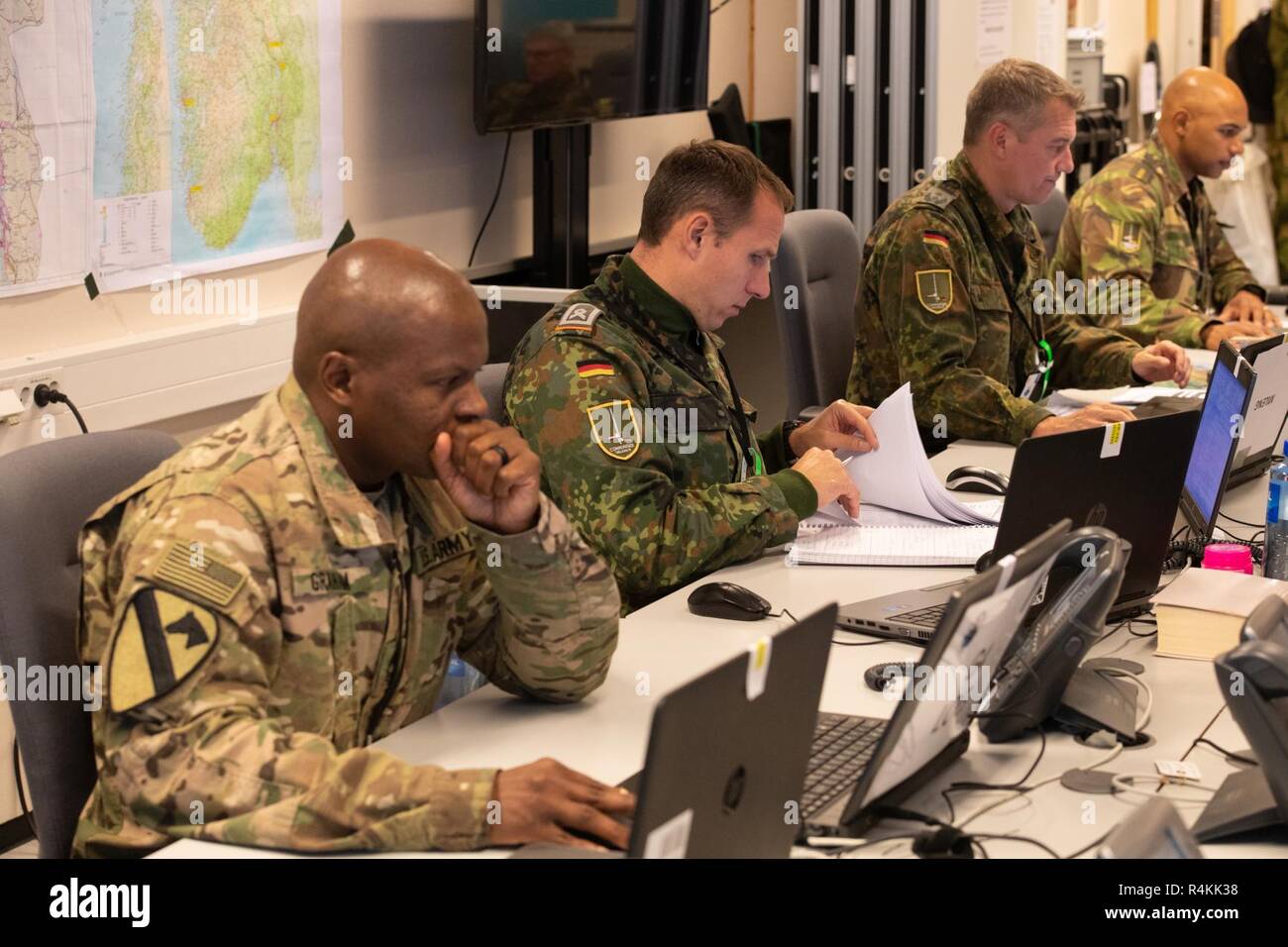 American and German soldiers work in the Tactical Operations Center at 1st German Netherlands Corps Headquarters for Trident Juncture 2018 in Jorstadmoen, Norway on October 26, 2018. The unit is part of NATO’s Very High Readiness Joint Task Force, which is exercising in Norway as part of Trident Juncture 2018. Stock Photo