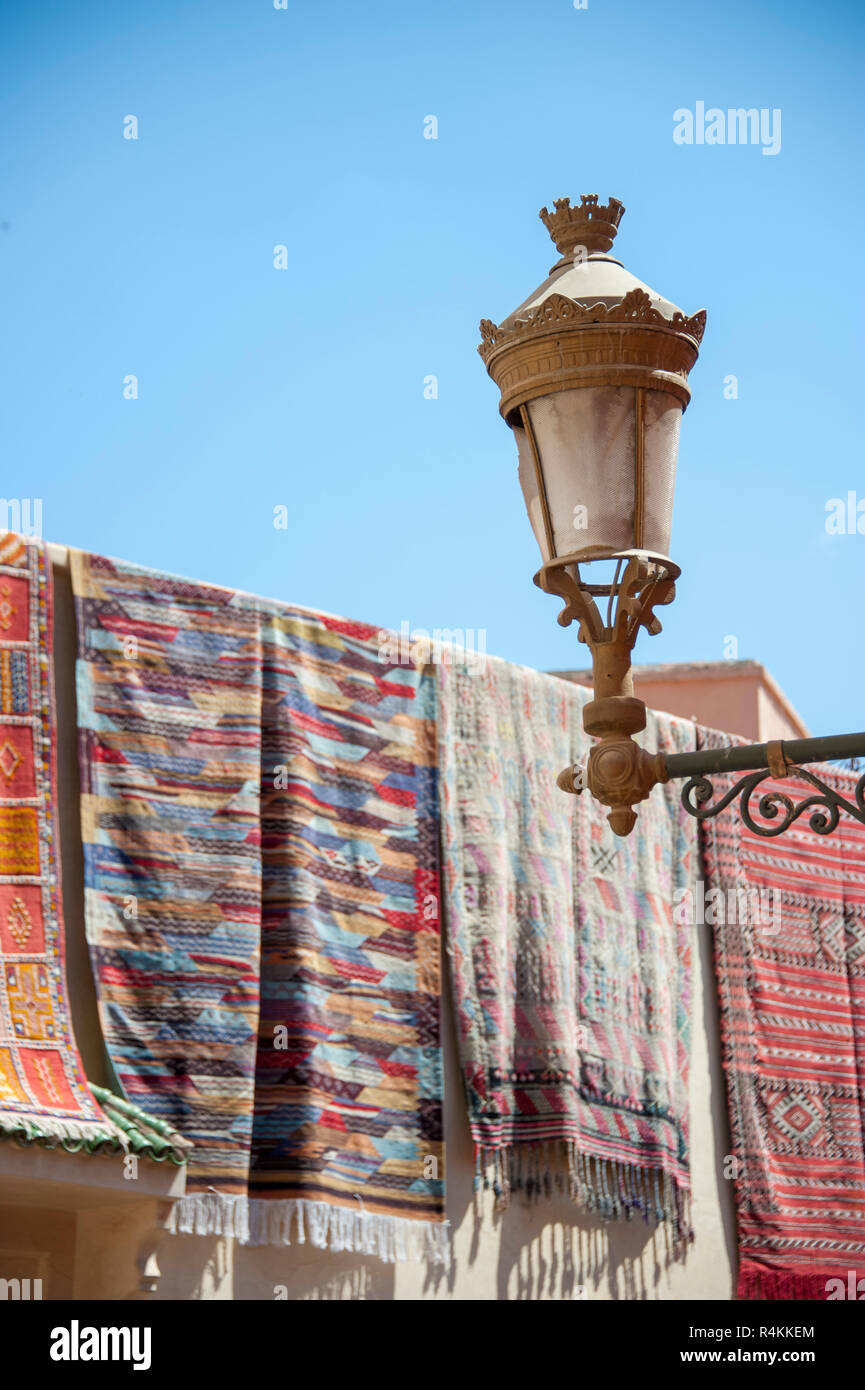 18-04-11. Marrakech, Morocco.  Old fashioned gas lamp in front of traditional rugs airing in the sunshine. Photo © Simon Grosset / Q Photography Stock Photo