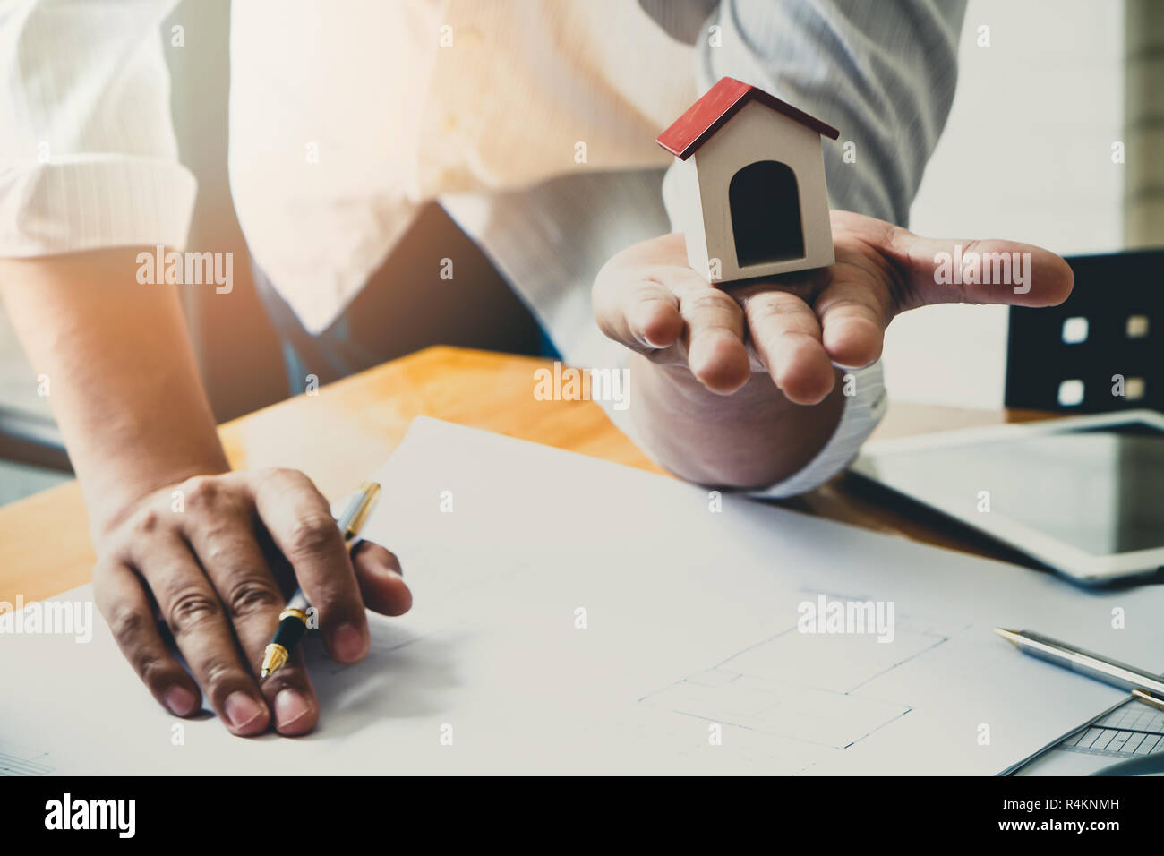 Architect or engineer using pen working on blueprint, architectural concept Stock Photo