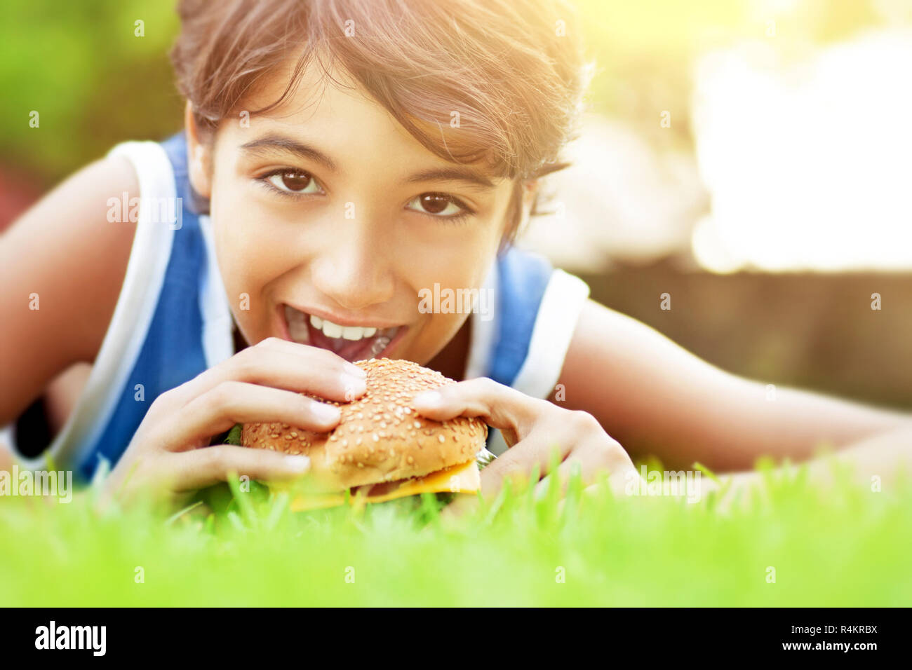 Happy boy eating burger Stock Photo