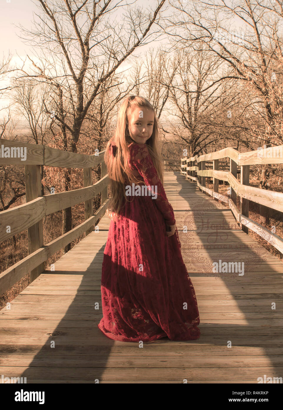 A model in forest in red dress simple beauty and poise with