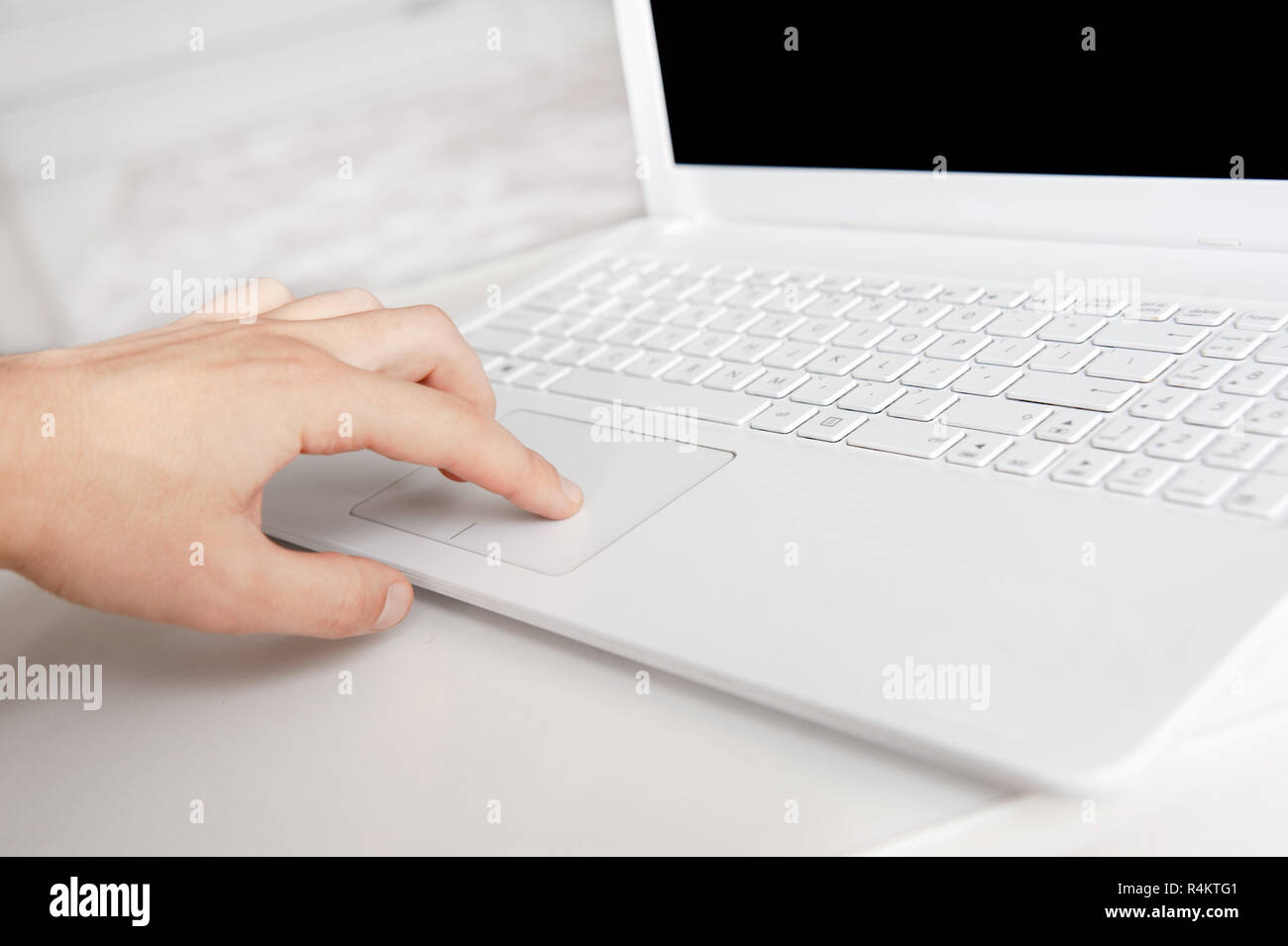 mans hand typing on white keyboard by fingers. white style workspace technics Stock Photo