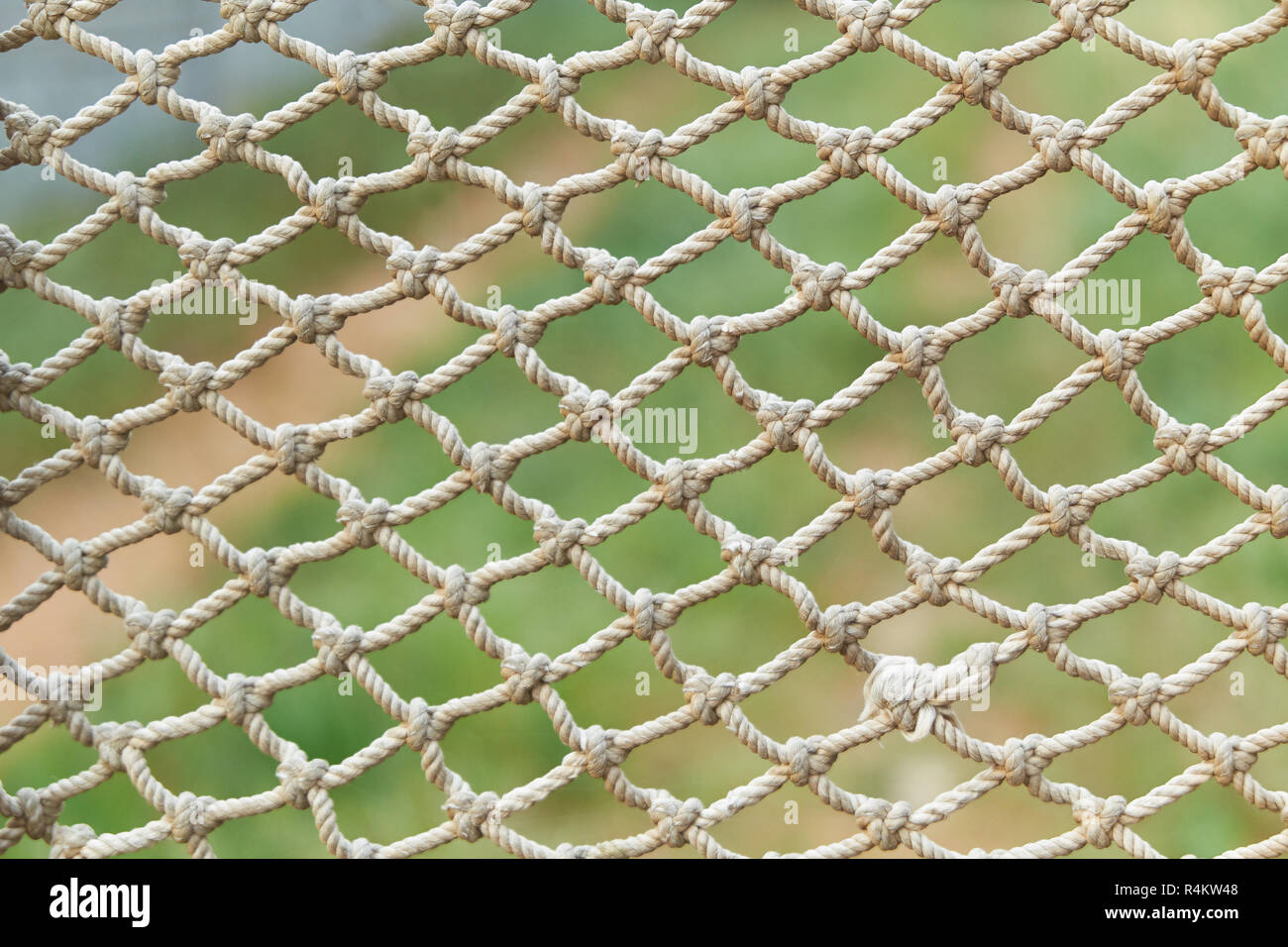 white vintage rope net texture is on green grass background. fishing nets  Stock Photo - Alamy
