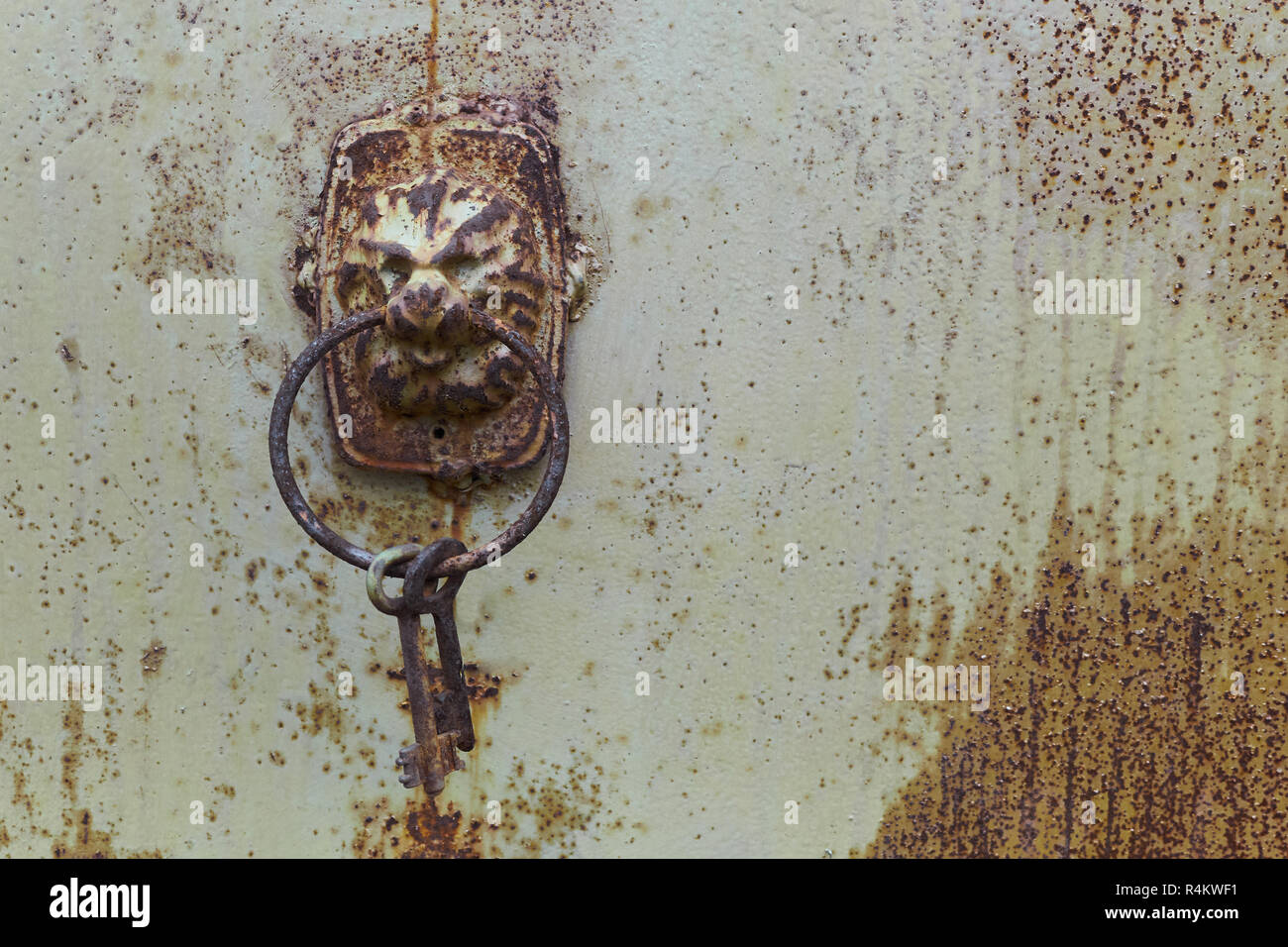 vintage shabby door iron lock in lion shape with keys on the ring Stock Photo