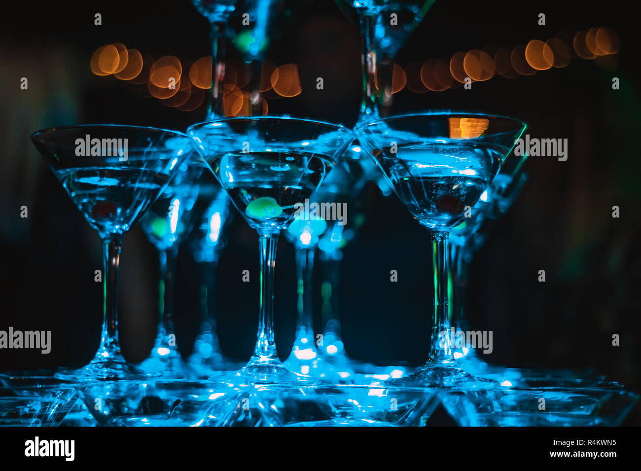 champagne pyramid in blue club lights. new year celebration concept ...