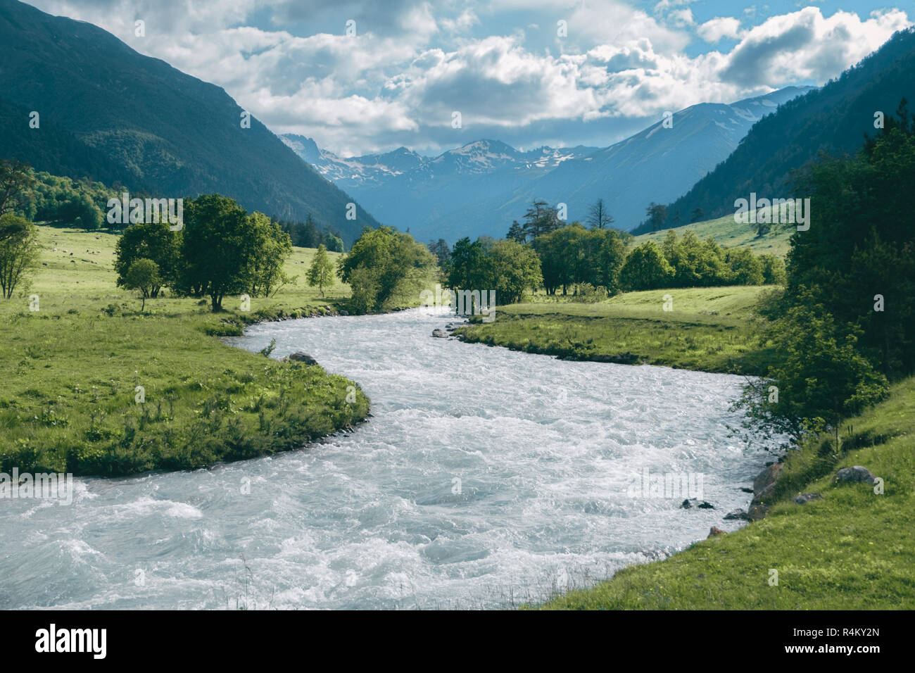 Highland Rivers highland river landscape with snowy mountain peaks and cloudy sky Stock ...