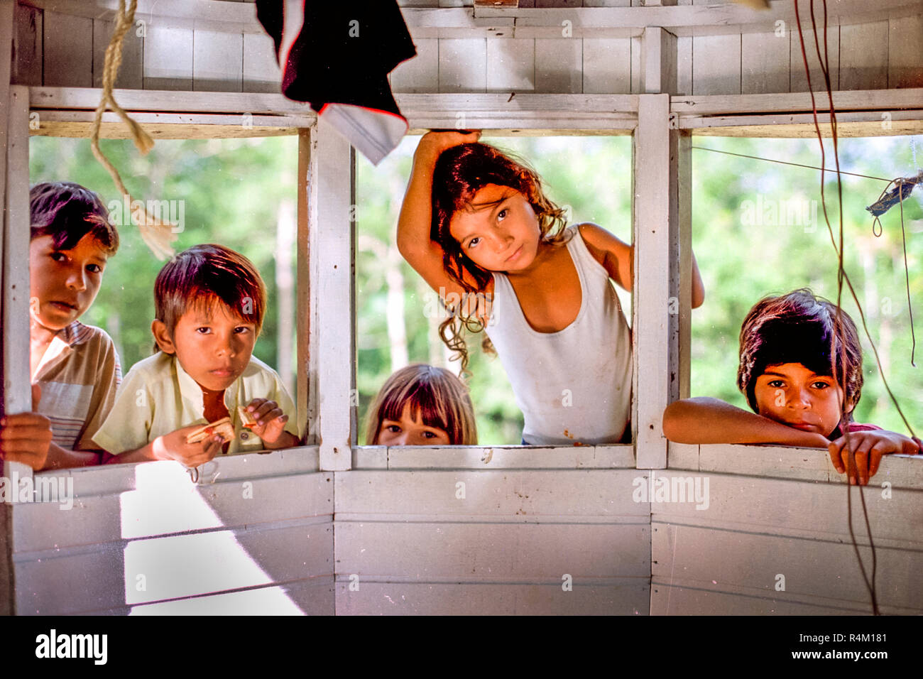 Brazilian Children playing on typical boat looking in camera Stock Photo