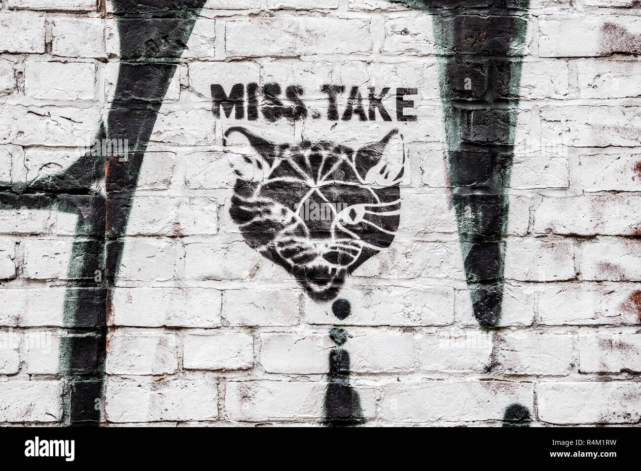 Miss Take. Portrait of a Cat as Graffiti on a Brick Wall. What does this cat graffiti allude to? The predatory art of cats or to the fact that the many cat photos on the Internet are a flaw? Stock Photo