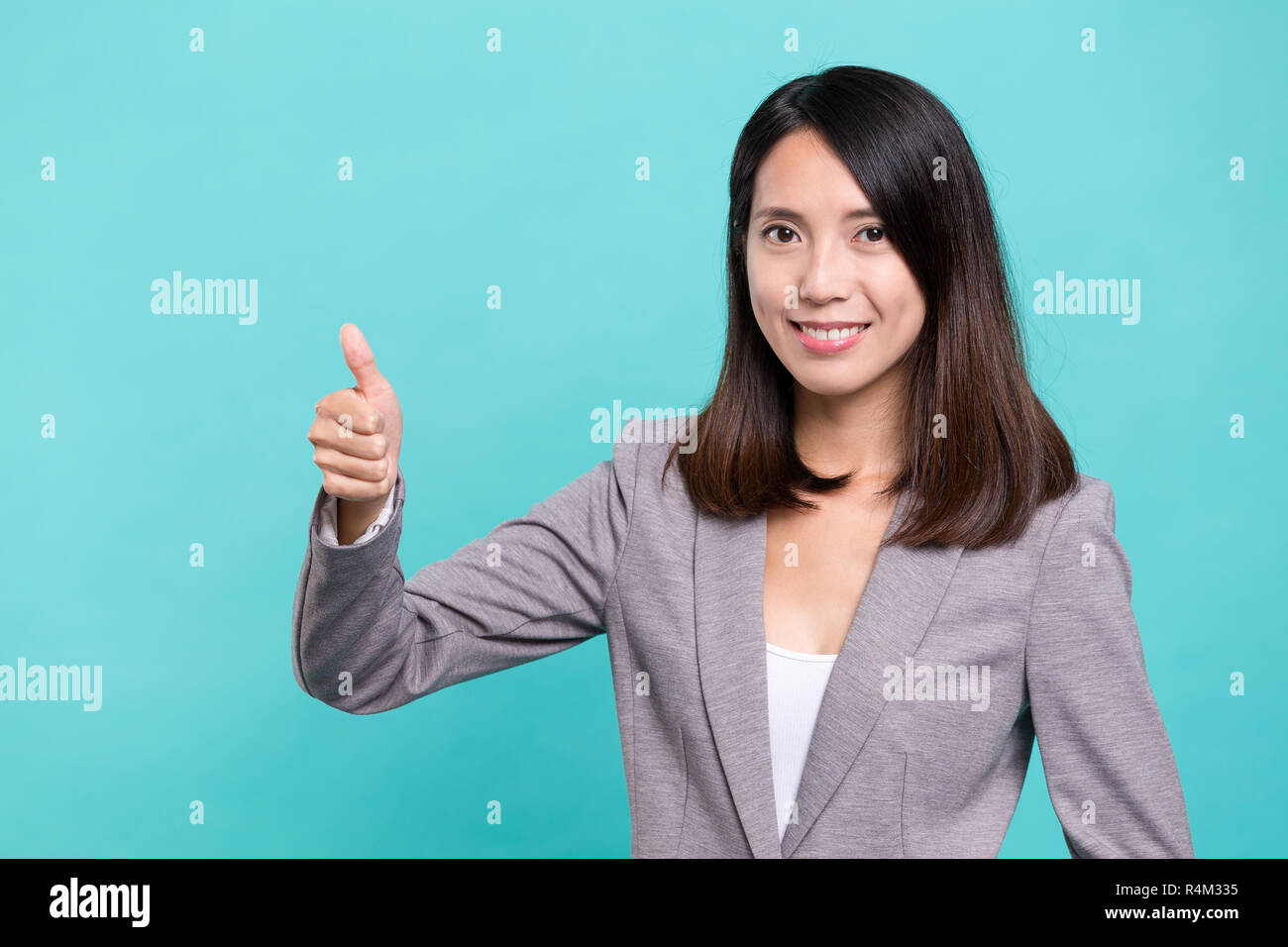 Laughing asian woman showing thumb hi-res stock photography and images ...
