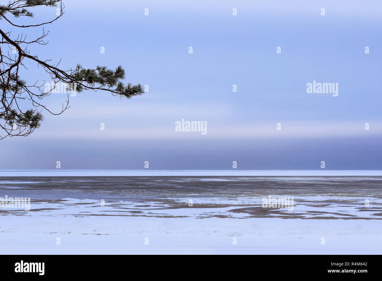Winter day on snowy shore of Narva Bay. Snow on the ice of the frozen Gulf of Finland. Narva-Joesuu resort town in North-East of Estonia Ida-Virumaa County. Severe Northern winter and snowy weather Stock Photo