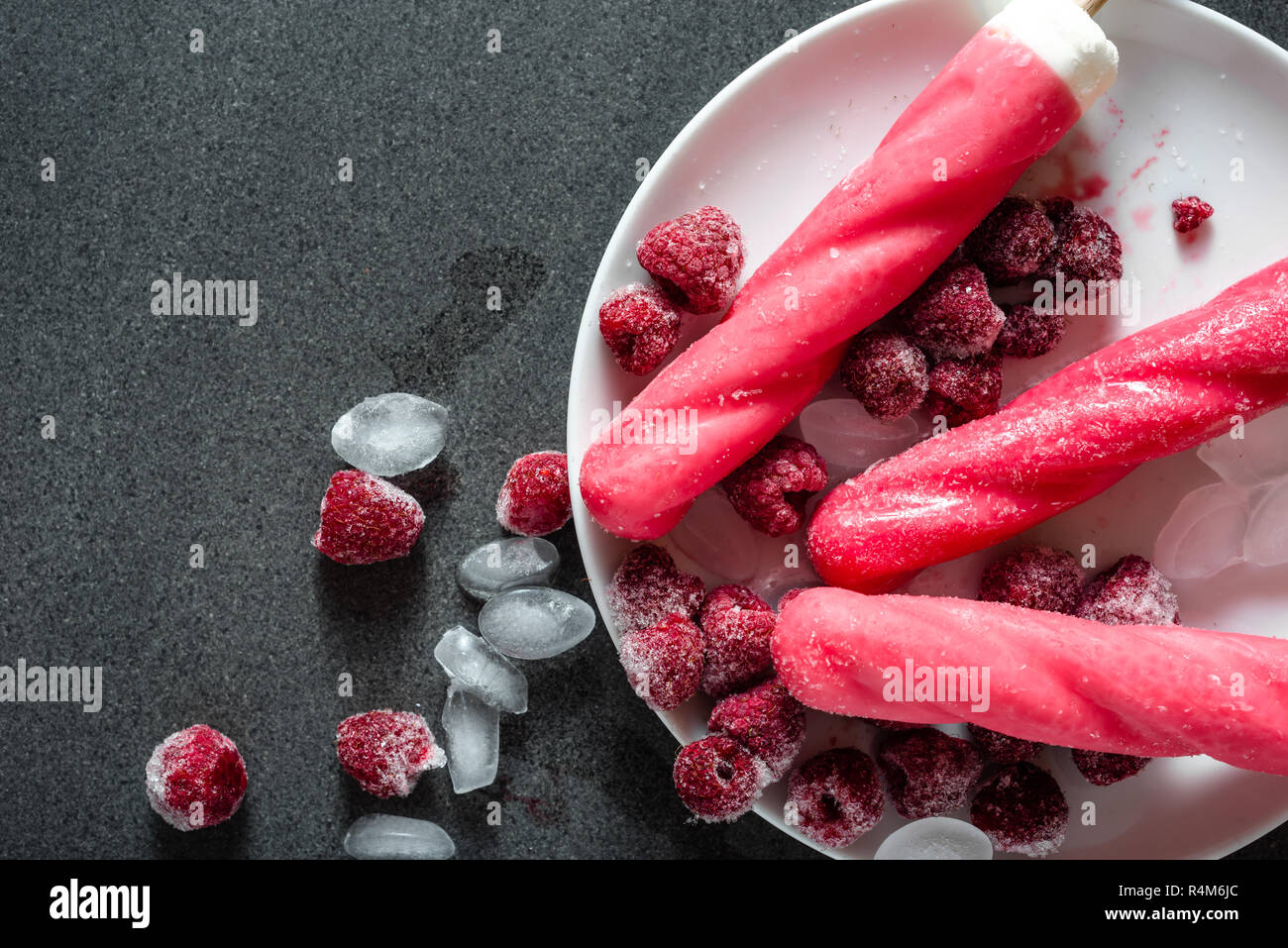 Red ice lolly with summer fruit, cold refreshing snack Stock Photo - Alamy
