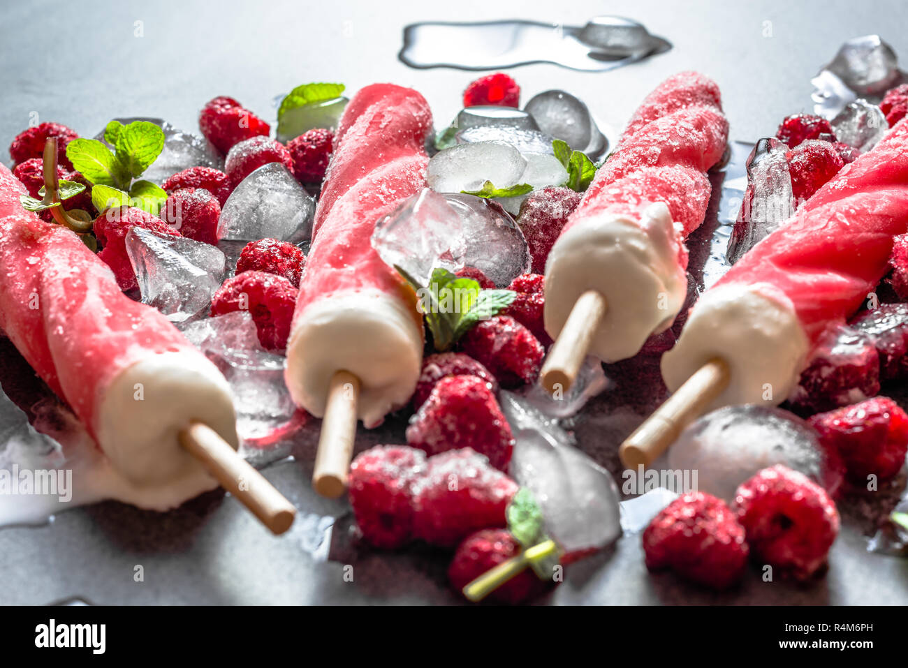 Flavored ice popsicles with frozen fruits, cold refreshing snack for summer Stock Photo