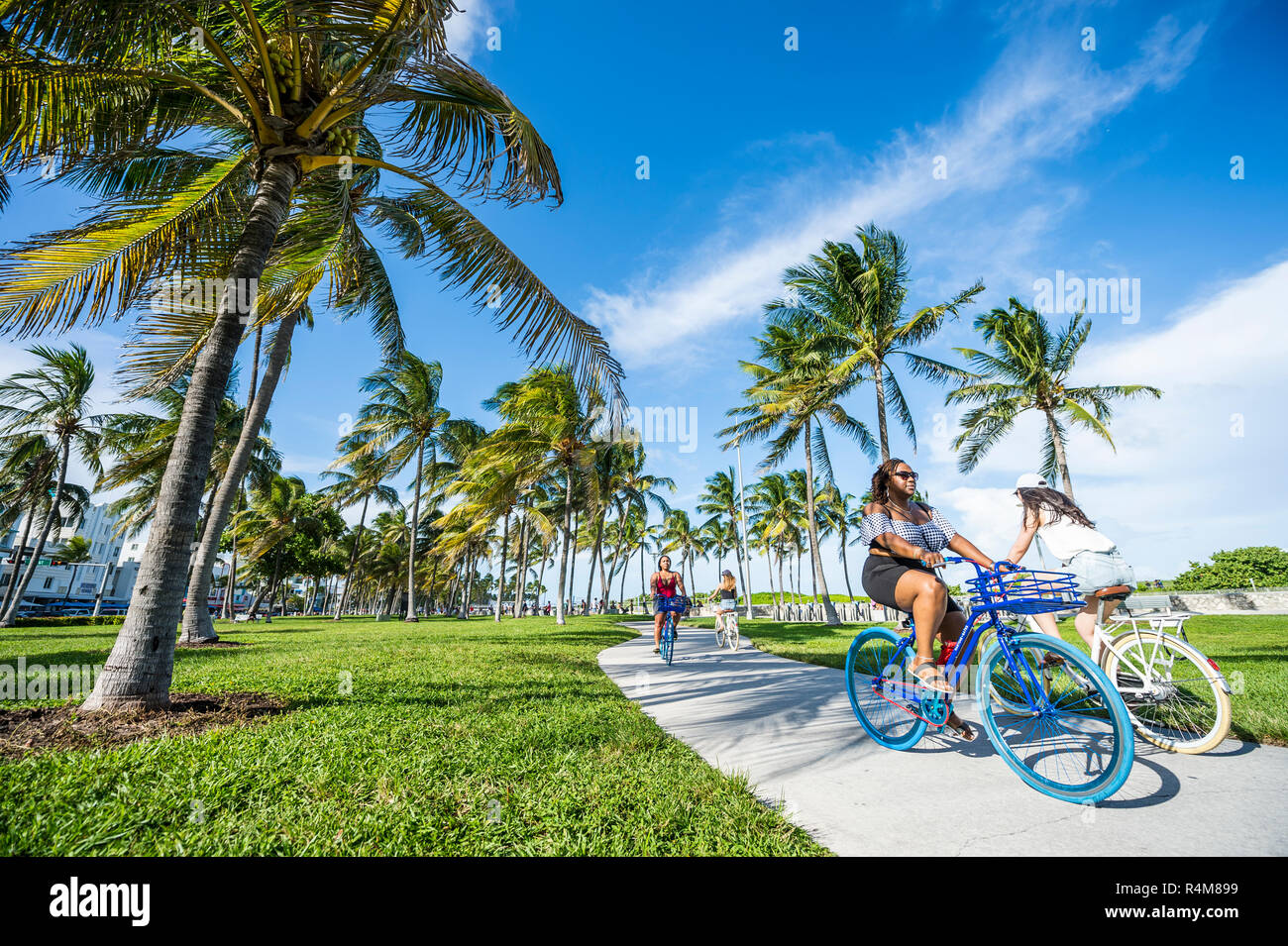 MIAMI - SEPTEMBER, 2018: Visitors ride colorful beach cruiser bicycles ...