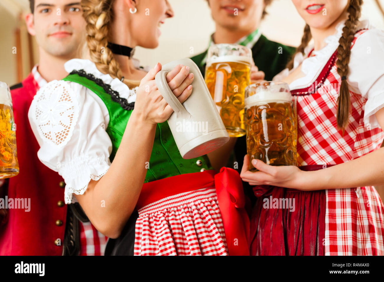 Young People In Traditional Bavarian Tracht In Restaurant Or Pub Stock young-people-in-traditional-bavarian-tracht-in-restaurant-or-pub-stock